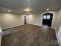 Open living room with hardwood floors showcasing seamless flow into adjacent rooms and abundant natural light at 424 20Th Ne Ave, Hickory, NC 28601