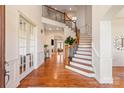 Grand foyer with staircase featuring wood floors, soaring ceilings and iron railing at 425 Gladelynn Way, Waxhaw, NC 28173