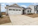 Charming gray home with a two-car garage and beautiful landscaping at 4255 Wild Ridge Dr, Charlotte, NC 28215