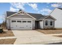 Charming gray home with a two-car garage and beautiful landscaping at 4255 Wild Ridge Dr, Charlotte, NC 28215