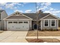 Charming gray home with a two-car garage and beautiful landscaping at 4255 Wild Ridge Dr, Charlotte, NC 28215