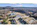 Stunning aerial view of houses in a neighborhood with community pond and mountain views at 427 Kentmere Ln, Lake Wylie, SC 29710