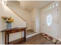 Bright foyer featuring hardwood floors, staircase, and decorative table at 4840 Autumn Leaf Ln, Charlotte, NC 28277