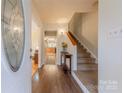 Inviting foyer with hardwood floors, staircase, and decorative glass front door at 4840 Autumn Leaf Ln, Charlotte, NC 28277