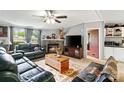 Cozy living room featuring fireplace, large tv, comfortable seating and rustic coffee table at 5128 Green Leaf Ct, Mount Holly, NC 28120