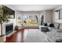 Bright living room showcasing the fireplace, natural light, and comfortable sectional sofa with throw pillows at 529 N Graham St # 2G, Charlotte, NC 28202