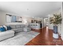 Open-concept living area with breakfast bar, modern decor, and hardwood flooring throughout at 529 N Graham St # 2G, Charlotte, NC 28202
