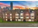 Beautiful condo building with manicured lawn and city skyline in the background at 529 N Graham St # 2G, Charlotte, NC 28202