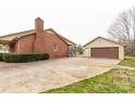 Side view of brick home and detached garage, showcasing ample parking and yard space at 705 Tirzah Rd, York, SC 29745