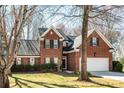 Attractive brick home with well-maintained landscaping, featuring a two-car garage and a welcoming entrance at 7562 Sedgebrook W Dr, Stanley, NC 28164