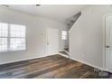 Open-concept living room features hardwood floors and plenty of natural light at 8247 Pozzi Rd, Charlotte, NC 28216