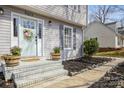 Charming front porch featuring a stylish door, potted plants, and a welcoming entrance at 9613 Central Dr, Mint Hill, NC 28227