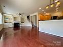 Spacious living room with hardwood floors, fireplace, and built-in shelves at 9684 Ravenscroft Nw Ln, Concord, NC 28027
