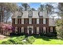 Charming two-story brick home with manicured lawn, black shutters, and a welcoming front door at 11122 Windgate Ct, Tega Cay, SC 29708