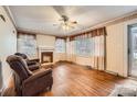 Spacious living room with hardwood floors, fireplace, and natural light from large windows at 12 Roberta Rd, Concord, NC 28027