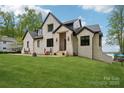 Stunning exterior view of the immaculate brick two-story home with professional landscaping at 121 Kelly Point Ln, Mooresville, NC 28117