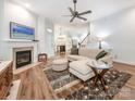 Bright living room with a fireplace, hardwood floors, and stylish furniture at 12432 Bradford Park Dr, Davidson, NC 28036