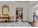 Foyer with marble floors, decorative mirror, and access to a wood-paneled living area at 1414 Biltmore Dr, Charlotte, NC 28207