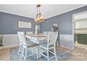 A stylish dining room is displayed with a modern chandelier, elegant decor, and comfortable seating for six at 1417 Shady Bark Dr, Gastonia, NC 28054