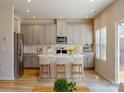 Inviting kitchen with an island, bar stools, stainless steel appliances, and wood flooring at 146 Aberdeen Dr, Salisbury, NC 28144