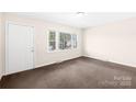 Cozy living room features a large window and neutral carpet at 1502 Northwoods Dr, Kings Mountain, NC 28086