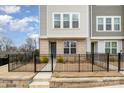 Inviting townhome entrance with a brick base, professional landscaping and a secure black metal fence at 2021 Summey Ave, Charlotte, NC 28205