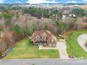 Stunning aerial view of the home showcasing the surrounding lush landscape and mature trees at 2036 Rocky Stream Rd, York, SC 29745