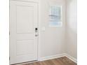 Clean entryway featuring a white door with a digital lock and a small window with blinds at 2100 Old Rivers Rd, Concord, NC 28027