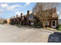 A row of attractive townhomes boasting brick chimneys and convenient parking spaces at 2324 Brookview Ct, Rock Hill, SC 29732