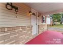 Welcoming front porch with brick accents and a bright white door at 2909 Glendale Ave, Kannapolis, NC 28081