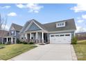 Charming single-Gathering home with a well-manicured lawn, covered porch, stone accents, and a long concrete driveway at 2929 Shumard Dr, Gastonia, NC 28054