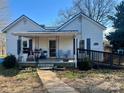 Inviting home features a cozy front porch with seating and a ramp for accessibility at 2940 Ambrose Dr, Gastonia, NC 28056