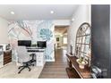 Stylish home office with a modern desk, chair, and decorative wallpaper at 3180 Streamside Dr, Davidson, NC 28036