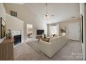 Bright living room with vaulted ceilings, a cozy fireplace, and neutral decor at 4226 Cornelia Ln, Rock Hill, SC 29732