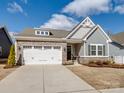 Inviting exterior showcases a well-maintained lawn, stone accents, and a two-car garage at 6420 Cambridge Dr, Harrisburg, NC 28075