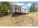 Charming single-story home featuring a covered porch with wood stairs and black painted foundation at 813 Carrid Dr, Gastonia, NC 28052