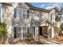 Charming townhouse exterior featuring neutral siding, green shutters, and a welcoming front porch at 9562 Littleleaf Dr, Charlotte, NC 28215