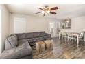 Spacious living room and dining area featuring modern gray floors and a large gray sectional sofa at 9562 Littleleaf Dr, Charlotte, NC 28215