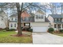 Charming two-story home with a two-car garage, manicured lawn, and mature trees at 1017 Anduin Falls Dr, Charlotte, NC 28269