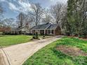 A cozy home with manicured lawn and a long driveway at 1030 Bolling Rd, Charlotte, NC 28207