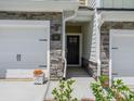 Charming entrance with stone accents around garage and front door. A beautiful place to call home at 109 Alluvium Ln, Waxhaw, NC 28173