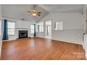 Spacious living room featuring hardwood floors, a fireplace, and vaulted ceilings, perfect for gatherings at 11000 White Stag Dr, Charlotte, NC 28269