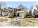 Exterior view of a two-story home with a well-manicured lawn and an attached one-car garage at 11708 Huxley Rd, Charlotte, NC 28277