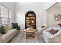 Bright living room with a large window and comfortable seating, showcasing an open and inviting space at 11708 Huxley Rd, Charlotte, NC 28277