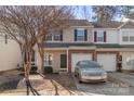 Charming townhome featuring a brick-accented facade, attached garage, and manicured landscaping at 13923 Singleleaf Ln, Charlotte, NC 28278