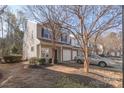 Inviting townhome with attached garage and multiple windows for abundant natural light at 13923 Singleleaf Ln, Charlotte, NC 28278