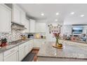 Well-lit kitchen with granite countertops, stylish backsplash, and stainless-steel appliances at 14621 Brannock Hills Dr, Charlotte, NC 28278