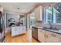 Open kitchen with granite island, stainless steel appliances, and seamless flow to living room at 1474 Callender Nw Ln, Charlotte, NC 28269