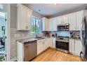 Well-lit kitchen with stainless steel appliances, granite countertops, and subway tile backsplash at 1474 Callender Nw Ln, Charlotte, NC 28269