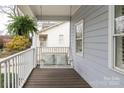 Inviting front porch with a cozy swing, perfect for relaxing outdoors at 1512 Pecan Ave, Charlotte, NC 28205